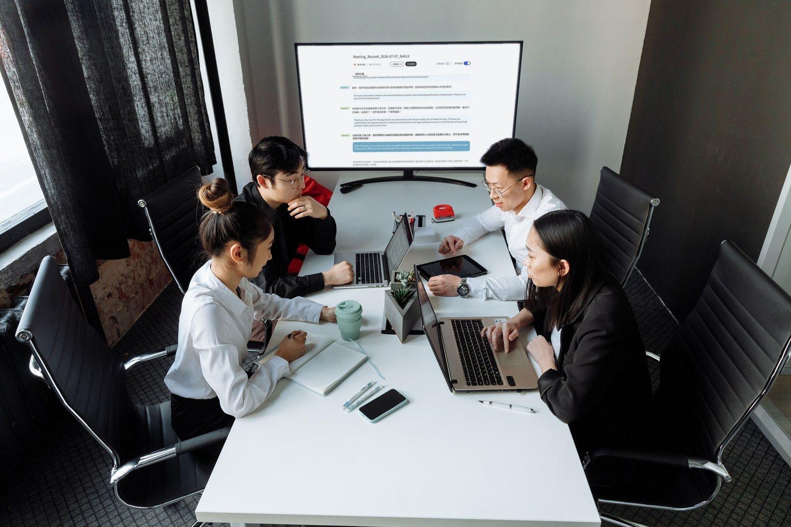 Advisory team meeting with the Meeting Ink live transcript shown on a screen in the meeting room